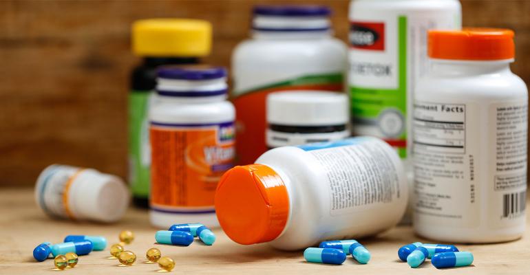 A collection of dietary supplement bottles with capsules and softgels